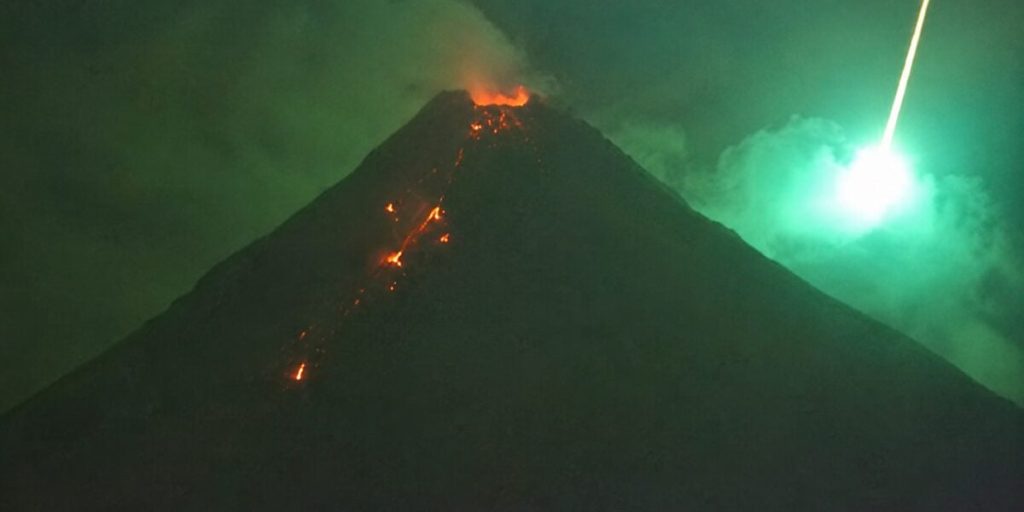 Spectacular images of the meteor exploding above an erupting volcano in ...