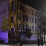 Kiev, strong explosions in the night: fire in a building, rocket fragments in the courtyard of a house