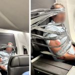 Violent passenger in flight, immobilized with tape and cable ties